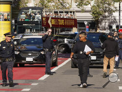 Police officers secure the area and investigate the scene of a shooting at Union Square in San Francisco, Saturday, Aug. 31, 2024. (Santiago Mejia/San Francisco Chronicle via AP)