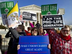 FILE - In this Jan. 18, 2019, file photo, anti-abortion activists protest outside of the U.S. Supreme Court, during the March for Life in Washington. Emboldened by the new conservative majority on the Supreme Court, anti-abortion lawmakers and activists in numerous states are pushing near-total bans on the procedure in a deliberate frontal attack on Roe v. Wade. (AP Photo/Jose Luis Magana, File)