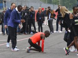 Olympic marathon champion Eliud Kipchoge pauses after crossing the finish line of a marathon race at the Monza Formula One racetrack, Italy, Saturday, May 6, 2017. Eliud Kipchoge was 26 seconds from making history on Saturday but in the end the Olympic champion was just short of becoming the first person to run a marathon in less than two hours. Kipchoge ran the 26.2 miles (42.2 kilometers) in 2 hours and 24 seconds, beating Dennis Kimetto's world record of 2:02:57, but the Kenyan failed to run the first su