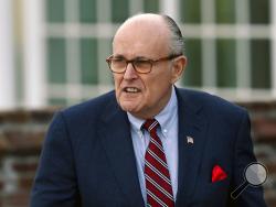 FILE - In this Nov. 20, 2016 file photo, former New York Mayor Rudy Giuliani arrives at the Trump National Golf Club Bedminster clubhouse in Bedminster, N.J. President Donald Trump's new lawyer Rudy Giuliani said Wednesday, May 2, 2018, the president repaid attorney Michael Cohen for a $130,000 payment to porn star Stormy Daniels. Giuliani made the revelation during an appearance on Fox News Channel's "Hannity." (AP Photo/Carolyn Kaster, File)