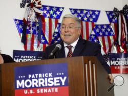 Denise Morrisey stands next to her husband, West Virginia Attorney General Patrick Morrisey, as he speaks at his campaign headquarters Tuesday, May 8, 2018, in Kearnesville, W.Va. (Ron Agnir/The Journal via AP)