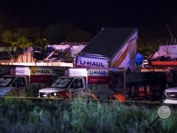 U-Haul trucks parked on Mundy Street in Wilkes-Barre Township, Pa., are damaged after a strong storm moved through the area on Wednesday, June 13, 2018. A powerful storm has pounded parts of Pennsylvania, damaging buildings, overturning cars and downing trees and power lines. (Christopher Dolan/The Citizens' Voice via AP)