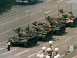FILE - In this June 5, 1989, file photo, a Chinese man stands alone to block a line of tanks heading east on Beijing's Changan Blvd. in Tiananmen Square on Jeff Widener who created the iconic image of "tank man" says its time for China's government to "come clean" about the bloody events of June 3-4 1989. (AP Photo/Jeff Widener, File)