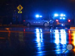 Virginia State Police vehicles block a street near the scene of a shooting at a municipal building in Virginia Beach, Va., early Saturday, June 1, 2019. A longtime city employee opened fire at a municipal building in Virginia Beach on Friday, killing several people and sending terrified co-workers scrambling for cover before police shot and killed him, authorities said. (AP Photo/Patrick Semansky)