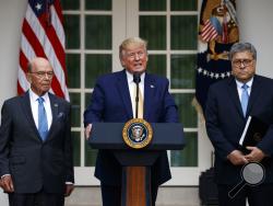 President Donald Trump, joined by Commerce Secretary Wilbur Ross, left, and Attorney General William Barr, speaks during an event about the census in the Rose Garden at the White House in Washington, Thursday, July 11, 2019. (AP Photo/Carolyn Kaster)