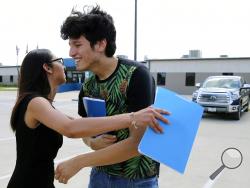 U.S. citizen Francisco Galicia, 18, gets a hug from his attorney, Claudia Galan, after his release from the South Texas Detention Facility in Pearsall, Texas, Tuesday, July 23, 2019. Galicia was released from immigration custody Tuesday after wrongfully being detained for more than three weeks. Galicia lives in the border city of Edinburg, Texas, and was traveling north with a group of friends when they were stopped at a Border Patrol inland checkpoint. According to Galan and the Dallas Morning News, agents