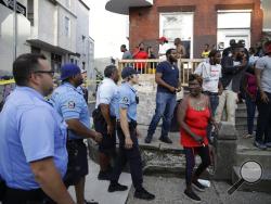 Police urge people to leave the area as they investigate an active shooting situation, Wednesday, Aug. 14, 2019, in the Nicetown neighborhood of Philadelphia. (AP Photo/Matt Rourke)