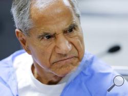FILE - In this Wednesday, Feb. 10, 2016, file photo, Sirhan Sirhan reacts during a parole hearing at the Richard J. Donovan Correctional Facility in San Diego. Sirhan, Sen. Robert F. Kennedy’s assassin, is hospitalized in stable condition after being stabbed by a fellow inmate at a Southern California prison, Friday, Aug. 30, 2019. (AP Photo/Gregory Bull, Pool, File)