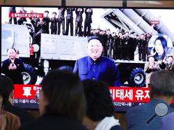 People watch a TV showing a file image of North Korean leader Kim Jong Un during a news program at the Seoul Railway Station in Seoul, South Korea, Wednesday, Oct. 2, 2019. North Korea on Wednesday fired projectiles toward its eastern sea, South Korea's military said, in an apparent display of its expanding military capabilities ahead of planned nuclear negotiations with the United States this weekend. (AP Photo/Ahn Young-joon)