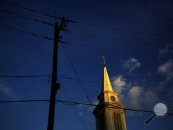 FILE - In this Tuesday, April 11, 2017 file photo, the sun sets on a Baptist church in Georgia. According to new data released Thursday, Oct. 17, 2019, by the Pew Research Center, the portion of Americans with no religious affiliation is rising significantly, in tandem with a sharp drop in the percentage that identifies as Christian. (AP Photo/David Goldman)