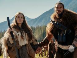 This image released by Apple TV Plus shows Jason Momoa, right, and Hera Hilmar in a scene from "See," premiering Friday, Nov. 1, 2019, on Apple TV Plus. (Apple TV Plus via AP)