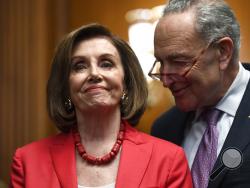 House Speaker Nancy Pelosi of Calif., left, and Senate Minority Leader Sen. Chuck Schumer of N.Y., right, listen as they wait to speak at an event on Capitol Hill in Washington, Tuesday, Nov. 12, 2019, regarding the earlier oral arguments before the Supreme Court in the case of President Trump's decision to end the Obama-era, Deferred Action for Childhood Arrivals (DACA), program. (AP Photo/Susan Walsh)