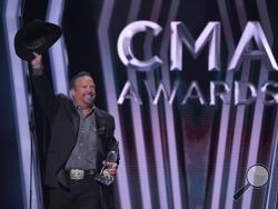 Garth Brooks accepts the award for entertainer of the year at the 53rd annual CMA Awards at Bridgestone Arena, Wednesday, Nov. 13, 2019, in Nashville, Tenn. (AP Photo/Mark J. Terrill)