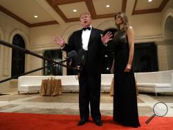President Donald Trump speaks to the media about the situation at the U.S. embassy in Baghdad, from his Mar-a-Lago property, Tuesday, Dec. 31, 2019, in Palm Beach, Fla., as Melania Trump stands next to him. (AP Photo/ Evan Vucci)