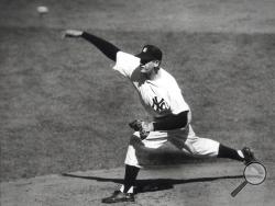FILE - In this Oct. 8, 1956, file photo, New York Yankees' Don Larsen delivers a pitch in the fourth inning of Game 5 against the Brooklyn Dodgers in the baseball World Series en route to the first World Series perfect game. The Yankees won 2-0 and went on to win the series. Larsen, the journeyman pitcher who reached the heights of baseball glory in 1956 for the Yankees when he threw a perfect game and the only no-hitter in World Series history, died Wednesday night, Jan. 1, 2020. He was 90. (AP Photo, File