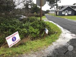 A sign expressing opposition to a plan by Facebook to build a landing spot for a submarine cable connecting America with Asia stands on property in the tiny community of Tierra del Mar, Ore., Wednesday, Jan. 8, 2020. (AP Photo/Andrew Selsky)