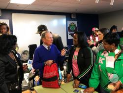In this Jan. 20, 2020, photo, former New York City Mayor and presidential candidate Michael Bloomberg talks to volunteers assembling backpacks at Scholarmade Achievement Place in Little Rock, Ark. (AP Photo/Andrew DeMillo)