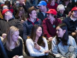 Students from local high schools and universities sit in the audience as they wait for the next speaker during the New Hampshire Youth Climate and Clean Energy Town Hall, Wednesday, Feb. 5, 2020, in Concord, N.H. (AP Photo/Mary Altaffer)