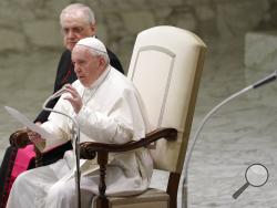 Pope Francis reads his message during the weekly general audience at the Vatican, Wednesday, Feb. 12, 2020. (AP Photo/Gregorio Borgia)