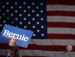A supporter of Democratic presidential candidate Sen. Bernie Sanders, I-Vt., applauds as Sanders speaks during a campaign rally Monday, March 9, 2020, in St. Louis. (AP Photo/Jeff Roberson)