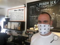 In this April 17, 2020, photo, Zachary Davis poses for a photo at The Penny Ice Creamery in Santa Cruz, Calif. That big companies and ones with questionable records received such precious financial aid during the chaotic last few weeks frustrates Davis, “We were feeling pretty good about where we were in the world. Now it’s just all turned upside down,” said Davis, who had to lay off 70 workers. (AP Photo/Martha Mendoza)