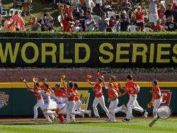 FILE - In this Sunday, Aug. 25, 2019, file photo, River Ridge, Louisiana, takes a victory lap around the field at Lamade Stadium after winning the Little League World Series Championship game against Curacao, 8-0, in South Williamsport, Pa. The 2020 Little League World Series and the championship tournaments in six other Little League divisions have been canceled because of the new coronavirus pandemic. (AP Photo/Gene J. Puskar, File)