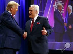 In this Feb. 29, 2020, file photo, President Donald Trump is greeted by Matt Schlapp, Chairman of the American Conservative Union, as the president arrives to speak at the Conservative Political Action Conference, at National Harbor, in Oxon Hill, Md. Republican political operatives are recruiting “pro-Trump” doctors to go on television to prescribe reviving the U.S. economy as quickly as possible, without waiting to meet the COVID-19 safety benchmarks proposed by public health experts. 