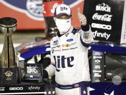 Brad Keselowski celebrates after winning the NASCAR Cup Series auto race at Charlotte Motor Speedway early Monday, May 25, 2020, in Concord, N.C. (AP Photo/Gerry Broome)