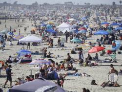 FILE - In this May 24, 2020, file photo, visitors gather on the beach during the Memorial Day weekend in Newport Beach, Calif. California's mood has gone from optimistic to sour as coronavirus cases and hospitalizations are on the rise heading into the July 4th weekend. Gov. Gavin Newsom has ordered bars and indoor restaurant dining closed in most of the state, many beaches are off limits, and he's imploring Californians to avoid holiday gatherings with family and friends. (AP Photo/Marcio Jose Sanchez, Fil