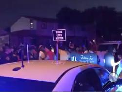 In this image made from video, protesters gather near the site of a police shooting, Sunday, Aug. 23 in Kenosha, Wisconsin. Officers deployed tear gas early Monday in an effort to disperse hundreds of people who took to the streets following a police shooting in Kenosha that also drew a harsh rebuke from the governor after a video posted on social media appeared to show officers shoot at a Black man’s back seven times as he leaned into a vehicle. (WDJT-TV via AP)