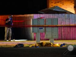 Officials work at a scene late Thursday, Sept. 3, 2020, where a man suspected of fatally shooting a supporter of a right-wing group in Portland, Ore., the week before was killed as investigators moved in to arrest him in Lacey, Wash. Michael Reinoehl, 48, was killed as a federal task force attempted to apprehend him in Lacey, a senior Justice Department official said. Reinoehl was the prime suspect in the killing of 39-year-old Aaron “Jay” Danielson, who was shot in the chest Saturday night, the official sa
