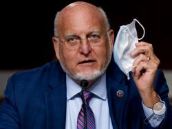 Centers for Disease Control and Prevention Director Dr. Robert Redfield holds up his mask as he speaks at a Senate Appropriations subcommittee hearing on a "Review of Coronavirus Response Efforts" on Capitol Hill, Wednesday, Sept. 16, 2020, in Washington. (AP Photo/Andrew Harnik, Pool)