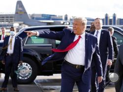 President Donald Trump gestures to supporters as he arrives at Minneapolis Saint Paul International Airport, Wednesday, Sept. 30, 2020, in Minneapolis. (AP Photo/Alex Brandon)