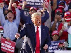 President Donald Trump works the crowd after speaking at a campaign rally Monday, Oct. 19, 2020, in Tucson, Ariz. (AP Photo/Ross D. Franklin)