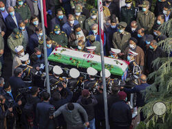In this photo released by the official website of the Iranian Defense Ministry, military personnel carry the flag draped coffin of Mohsen Fakhrizadeh, a scientist who was killed on Friday, in a funeral ceremony in Tehran, Iran, Monday, Nov. 30, 2020. Iran held the funeral service for Fakhrizadeh, who founded its military nuclear program two decades ago, with the Islamic Republic's defense minister vowing to continue the man's work "with more speed and more power." (Iranian Defense Ministry via AP)