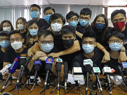 FILE - In this July 15, 2020, file photo, pro-democracy activists who were elected from unofficial pro-democracy primaries, including Joshua Wong, left, attend a press conference in Hong Kong. About 50 Hong Kong pro-democracy figures were arrested by police on Wednesday, Jan. 6, 2021 under a national security law, following their involvement in an unofficial primary election last year held to increase their chances of controlling the legislature, according to local media reports. (AP Photo/Kin Cheung, File)