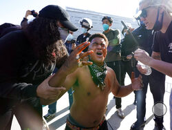 A counter demonstrator, center, yells after getting maced in the face by far-right demonstrators outside of City Hall Wednesday, Jan. 6, 2021, in Los Angeles. Demonstrators supporting President Donald Trump are gathering in various parts of Southern California as Congress debates to affirm President-elect Joe Biden's electoral college victory. (AP Photo/Marcio Jose Sanchez)