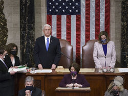 Vice President Mike Pence and Speaker of the House Nancy Pelosi, D-Calif., read the final certification of Electoral College votes cast in November's presidential election during a joint session of Congress after working through the night, at the Capitol in Washington, Thursday, Jan. 7, 2021. Violent protesters loyal to President Donald Trump stormed the Capitol Wednesday, disrupting the process. (AP Photo/J. Scott Applewhite, Pool)
