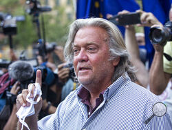 FILE - In this Aug. 20, 2020, file photo, President Donald Trump's former chief strategist, Steve Bannon, speaks with reporters in New York after pleading not guilty to charges that he ripped off donors to an online fundraising scheme to build a southern border wall. Trump is expected to pardon Bannon, Wednesday, Jan. 20, 2021, as part of a flurry of last-minute clemency action that appears to be still in flux in the last hours of his presidency. (AP Photo/Eduardo Munoz Alvarez, File)