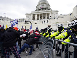 FILE - In this Wednesday, Jan. 6, 2021 file photo, Trump supporters try to break through a police barrier at the Capitol in Washington. Right-wing extremism has previously mostly played out in isolated pockets of America or in smaller cities. In contrast, the deadly attack by rioters on the U.S. Capitol targeted the very heart of government. It brought together members of disparate groups, creating the opportunity for extremists to establish links with each other. (AP Photo/Julio Cortez, File)