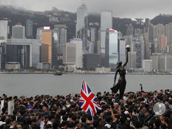 FILE - In this July 7, 2019, file photo, thousands of protesters carrying the British flag march near the harbor of Hong Kong. Thousands of people from Hong Kong are fleeing their hometown since Beijing imposed a draconian national security law on the territory in the summer 2020. Many say China’s encroachment on their way of life and civil liberties has become unbearable, and they want to seek a better future for their children abroad. (AP Photo/Kin Cheung, File)