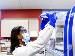 Clinical lab scientist Selam Bihon processes upper respiratory samples from patients suspected of having COVID-19 at the Stanford Clinical Virology Laboratory on Wednesday, Feb. 3, 2021, in Palo Alto, Calif. Viruses mutate constantly. To stay ahead of the threat, scientists analyze samples for genetic changes, watching closely for ones that might make the virus more infectious or more deadly. (AP Photo/Noah Berger)