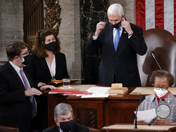 In this Jan. 6, 2021, photo, Senate Parliamentarian Elizabeth MacDonough, left, works beside Vice President Mike Pence during the certification of Electoral College ballots in the presidential election, in the House chamber at the Capitol in Washington. Shortly afterward, the Capitol was stormed by rioters determined to disrupt the certification. MacDonough has guided the Senate through two impeachment trials, vexed Democrats and Republicans alike with parliamentary opinions and helped rescue Electoral Coll