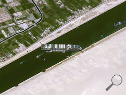 This satellite image from Cnes2021, Distribution Airbus DS, shows the cargo ship MV Ever Given stuck in the Suez Canal near Suez, Egypt, Thursday, March 25, 2021. The skyscraper-sized cargo ship wedged across Egypt's Suez Canal further imperiled global shipping Thursday as at least 150 other vessels needing to pass through the crucial waterway idled waiting for the obstruction to clear, authorities said. (Cnes2021, Distribution Airbus DS via AP)
