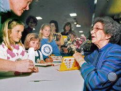 FILE - In this April 19, 1998 file photo, Beverly Cleary signs books at the Monterey Bay Book Festival in Monterey, Calif. The beloved children's author, whose characters Ramona Quimby and Henry Huggins enthralled generations of youngsters, has died. She was 104. Cleary's publisher, HarperCollins, announced her death Friday, March 26, 2021. In a statement, the company said Cleary died in Carmel, California, her home since the 1960s, on Thursday. No cause of death was given. (Vern Fisher/The Monterey County 