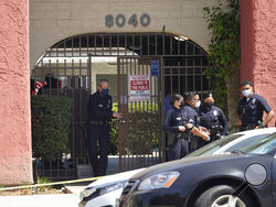 Los Angeles Police Chief Michel Moore exits an apartment complex as police investigate in Reseda, Calif., Saturday, April 10, 2021. The mother of three children — all under the age of 5 — found slain inside a Los Angeles apartment Saturday morning has been arrested, police said. (AP Photo/Damian Dovarganes)