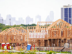 The frame of new home under construction sits in a neighborhood under development in north Dallas, Thursday, April 15, 2021. The first numbers from the 2020 census show southern and western states gaining congressional seats. The once-a-decade head count shows where the population grew during the past 10 years and where it shrank. (AP Photo/LM Otero)