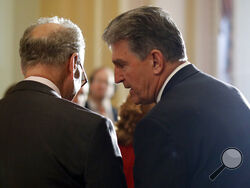 In this May 2, 2017, file photo, Sen. Joe Manchin, D-W.Va., right, speaks to then-Senate Minority Leader Charles Schumer, D-N.Y. during a news conference on Capitol Hill in Washington. Schumer warned his Democratic colleagues that June will "test our resolve" as senators return Monday to consider infrastructure, voting rights and other priorities. Six months into Democrats' hold on Washington, the senators are under enormous pressure to make gains on Democrats' campaign promises. (AP Photo/Carolyn Kaster, F