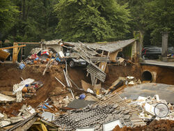 Debris of collapsed houses is pictures in the Blessem district of Erftstadt, Germany, Friday, July 16, 2021. Heavy rains caused mudslides and flooding in the western part of Germany. Multiple have died and dozens are missing as severe flooding in Germany and Belgium turned streams and streets into raging, debris-filled torrents that swept away cars and toppled houses. (David Young/dpa via AP)