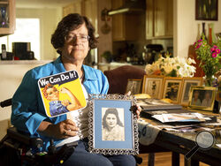 Dorene Giacopini holds up a photo of her mother Primetta Giacopini while posing for a photo at her home in Richmond, Calif. on Monday, Sept 27, 2021. Primetta Giacopini's life ended the way it began — in a pandemic. She was two years old when she lost her mother to the Spanish flu in Connecticut in 1918. Giacopini contracted COVID-19 earlier this month. The 105-year-old struggled with the disease for a week before she died Sept. 16. (AP Photo/Josh Edelson)